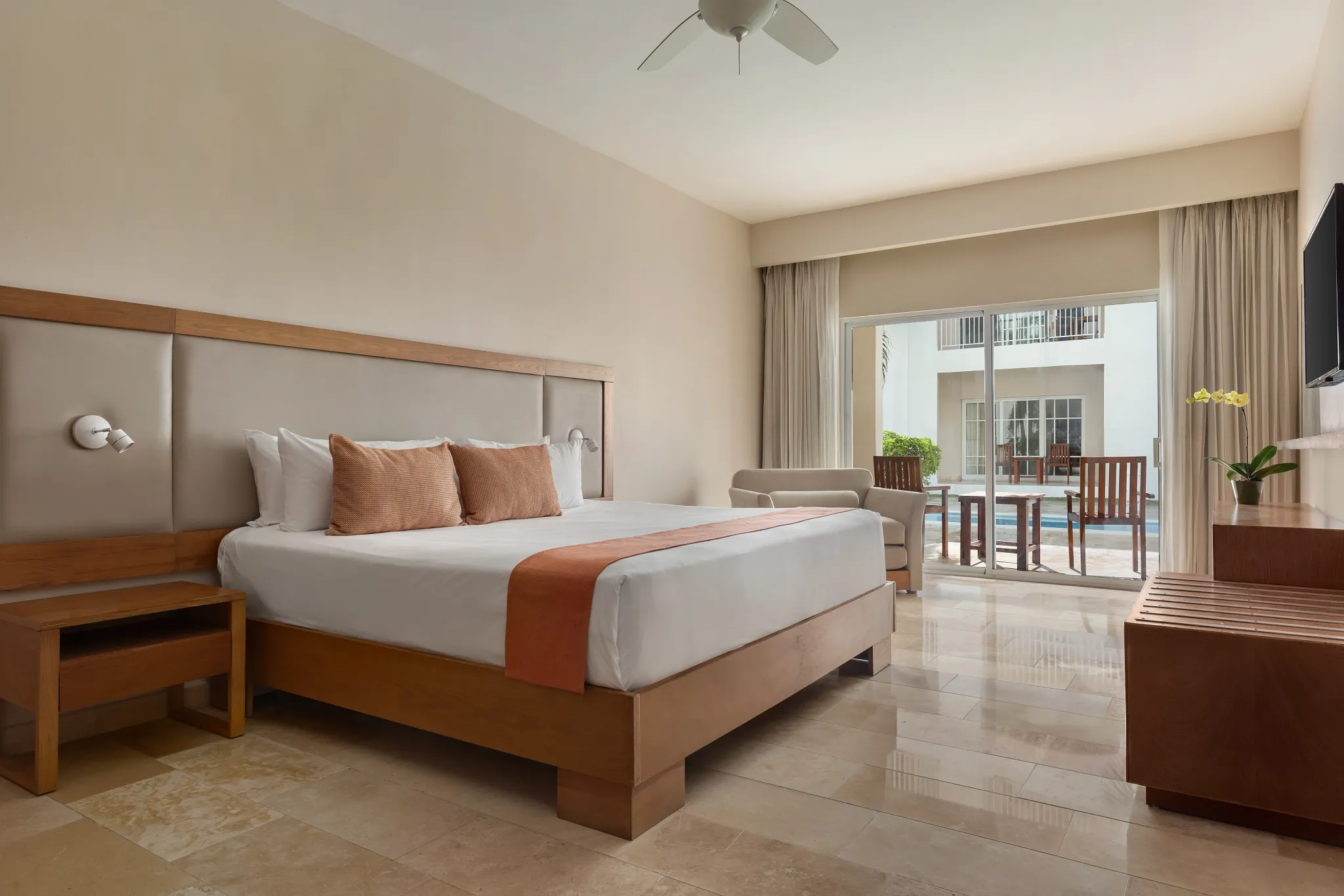 Deluxe Pool View room with king-size bed and private terrace at Sunscape Coco Punta Cana.