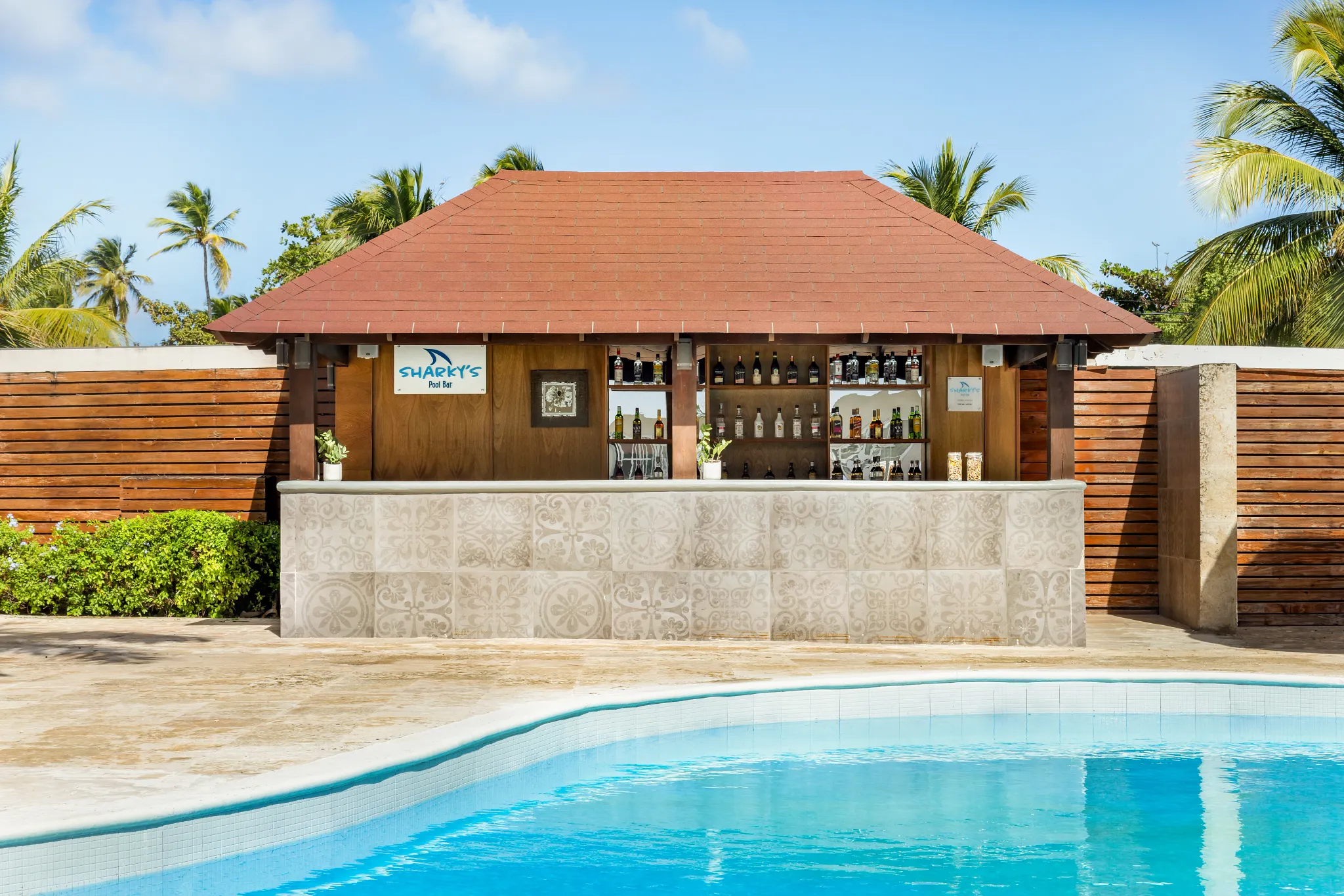 Sharky’s bar at Sunscape Coco Punta Cana featuring lively tropical décor, casual outdoor seating, and refreshing island cocktails.