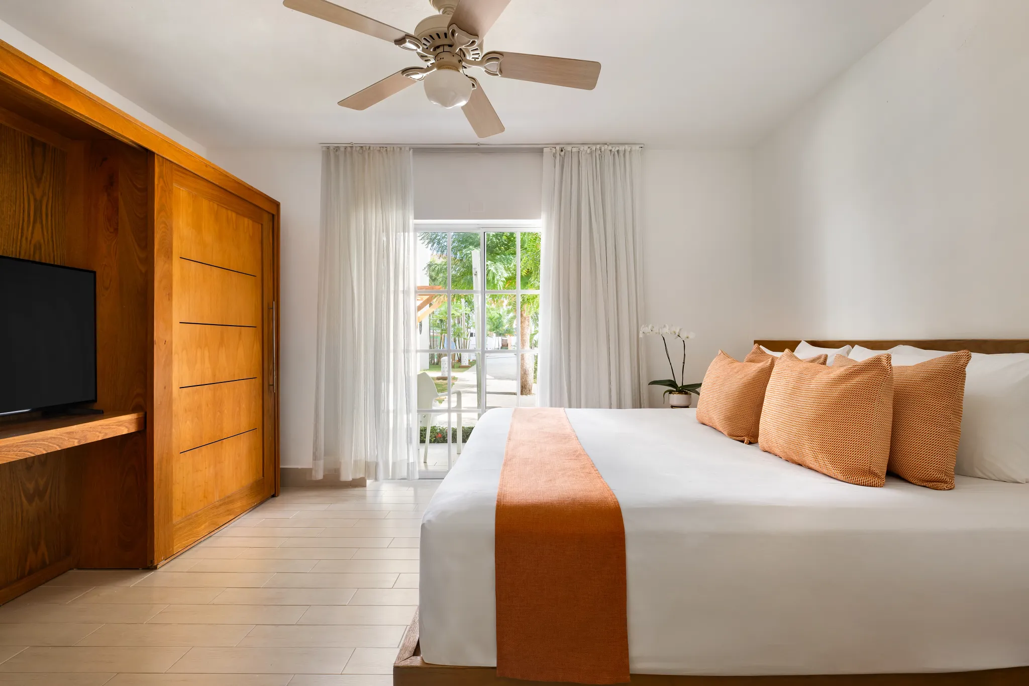 Sun Club 3-Bedroom Family Suite Tropical View king bedroom at Sunscape Coco Punta Cana with garden views.