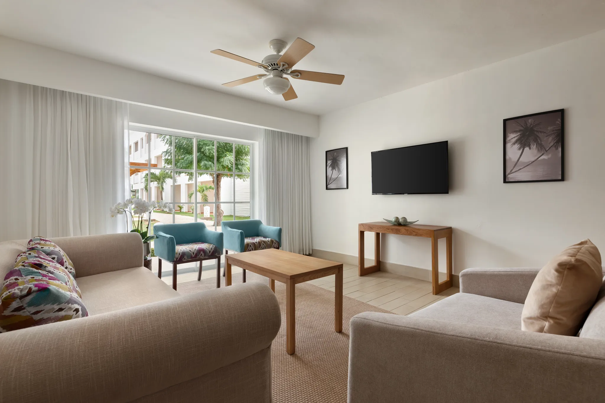 Sun Club 3-Bedroom Family Suite Tropical View living room with seating area at Sunscape Coco Punta Cana.