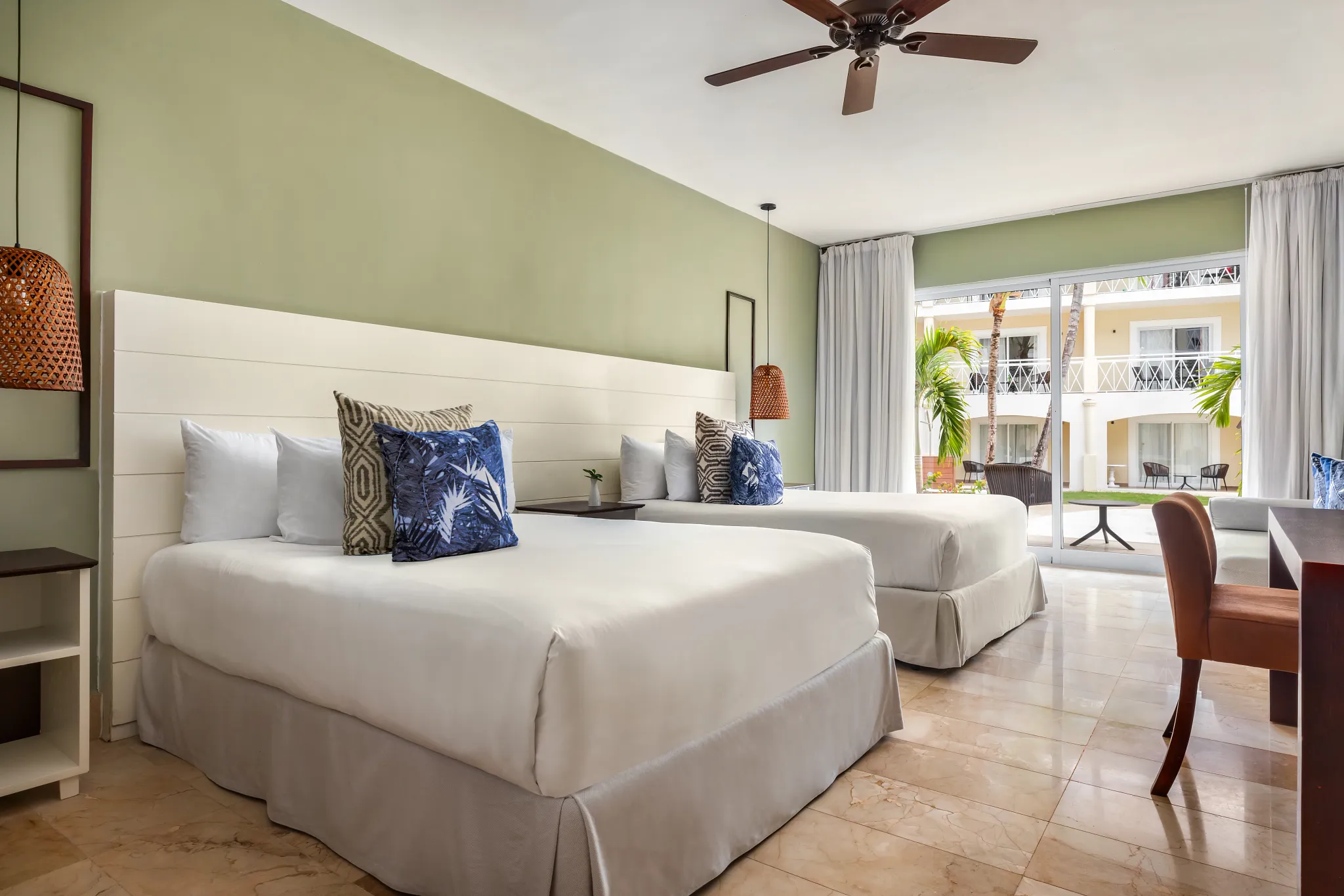 Sun Club Junior Suite Pool View with two double beds and private terrace at Sunscape Coco Punta Cana.