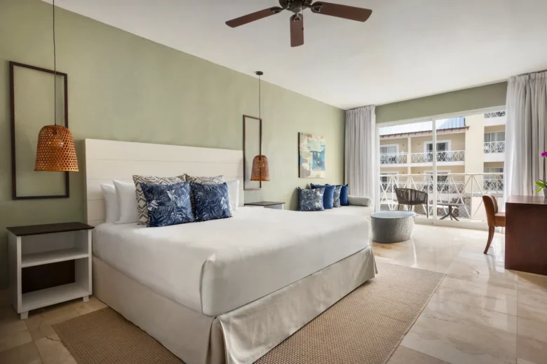 Sun Club Junior Suite Pool View with king-size bed and private balcony at Sunscape Coco Punta Cana.