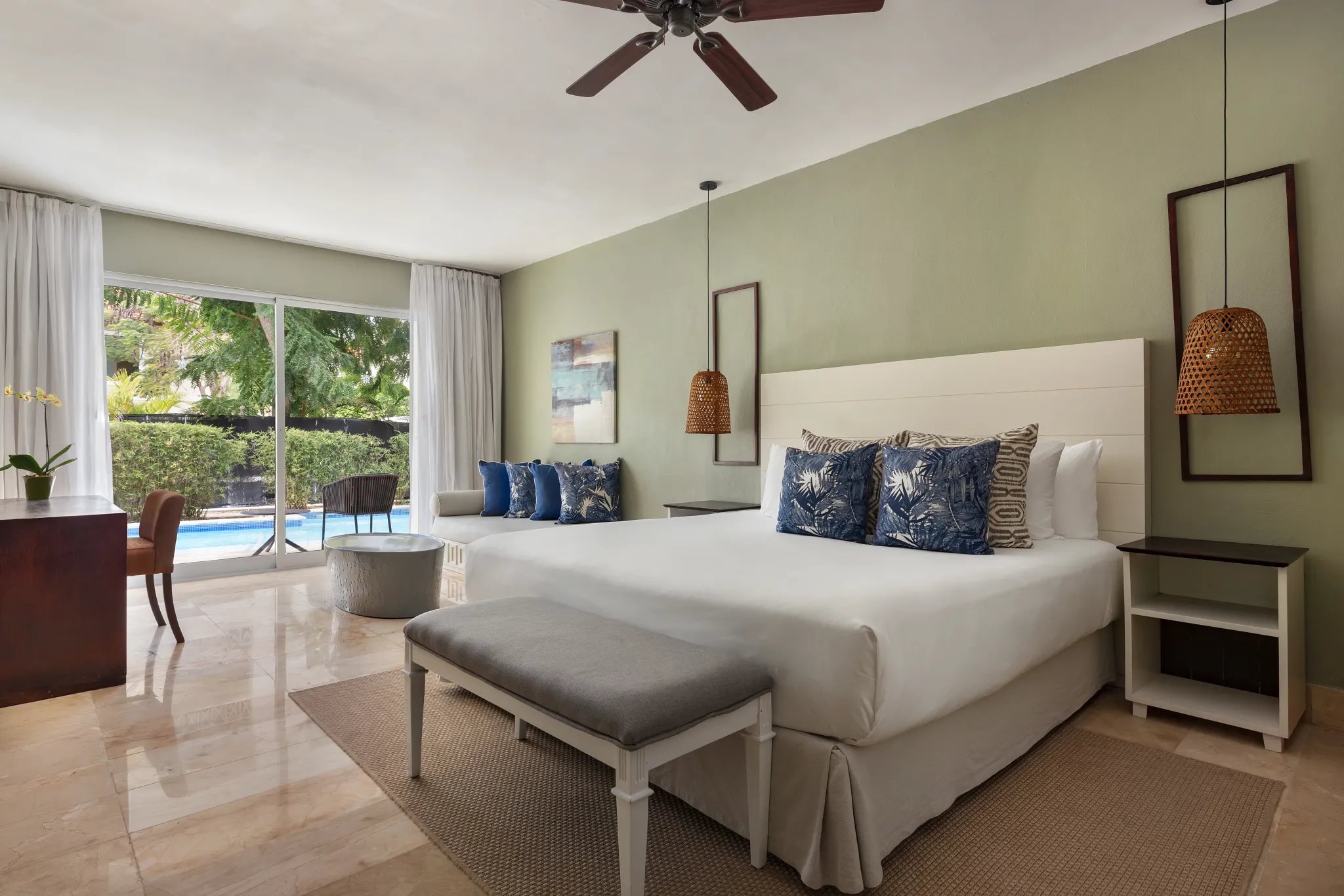 Luxury swim-out junior suite with king bed, tropical décor, and direct pool access at Sunscape Coco Punta Cana.