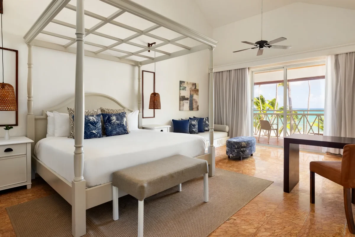 Oceanfront premium suite with canopy king bed and private balcony at Sunscape Coco Punta Cana.