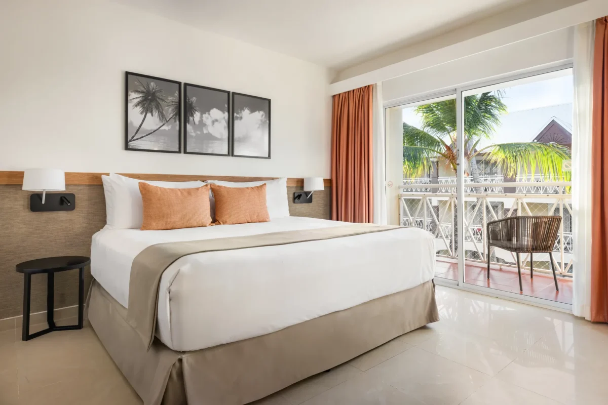 Sun Club Superior Tropical View room with king-size bed and private balcony at Sunscape Coco Punta Cana.