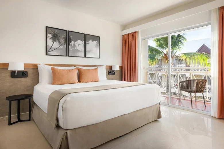 Sun Club Superior Tropical View room with king-size bed and private balcony at Sunscape Coco Punta Cana.