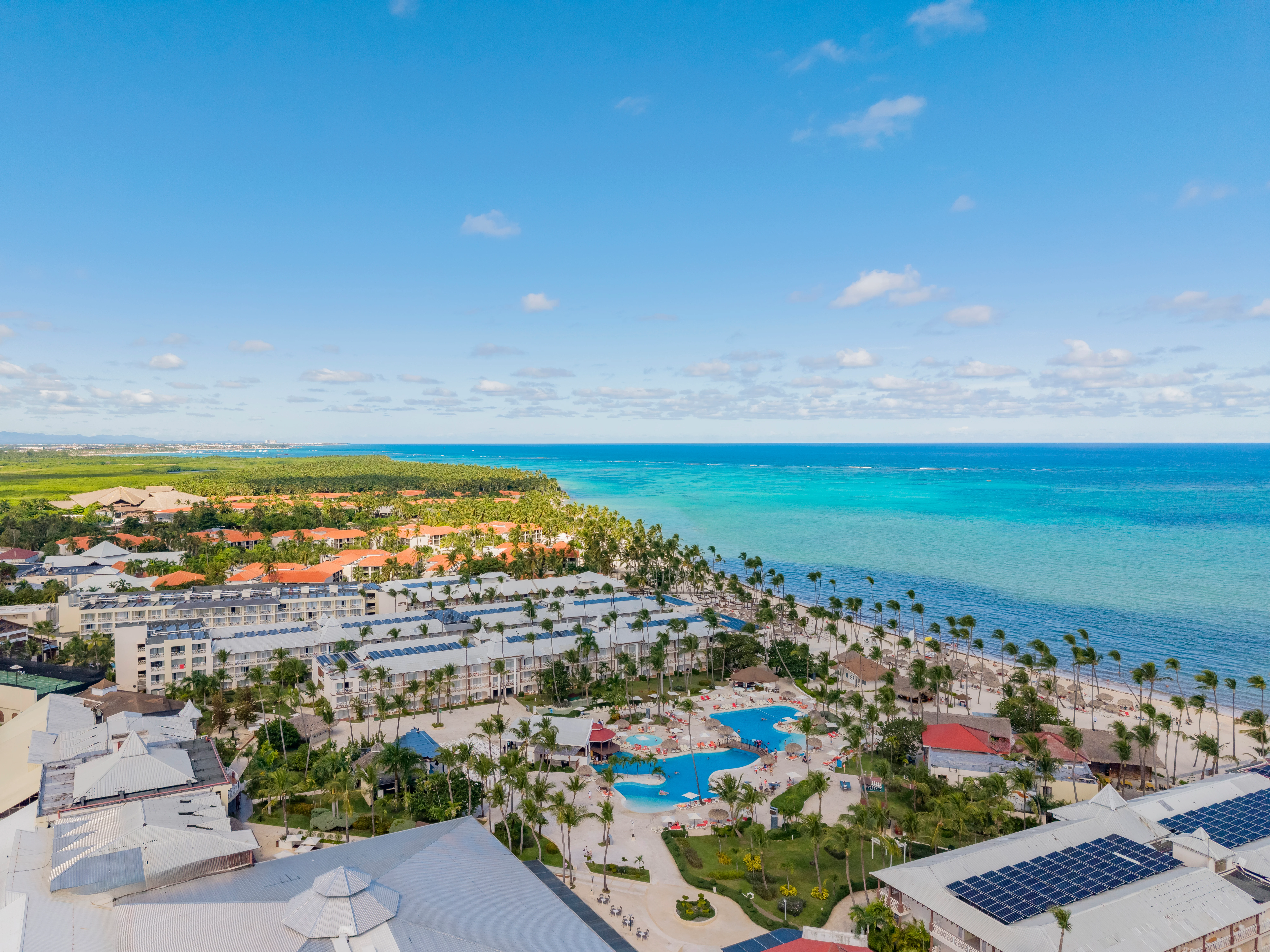 Aerial view of Sunscape Coco Punta Cana Resort along the turquoise Caribbean coastline.