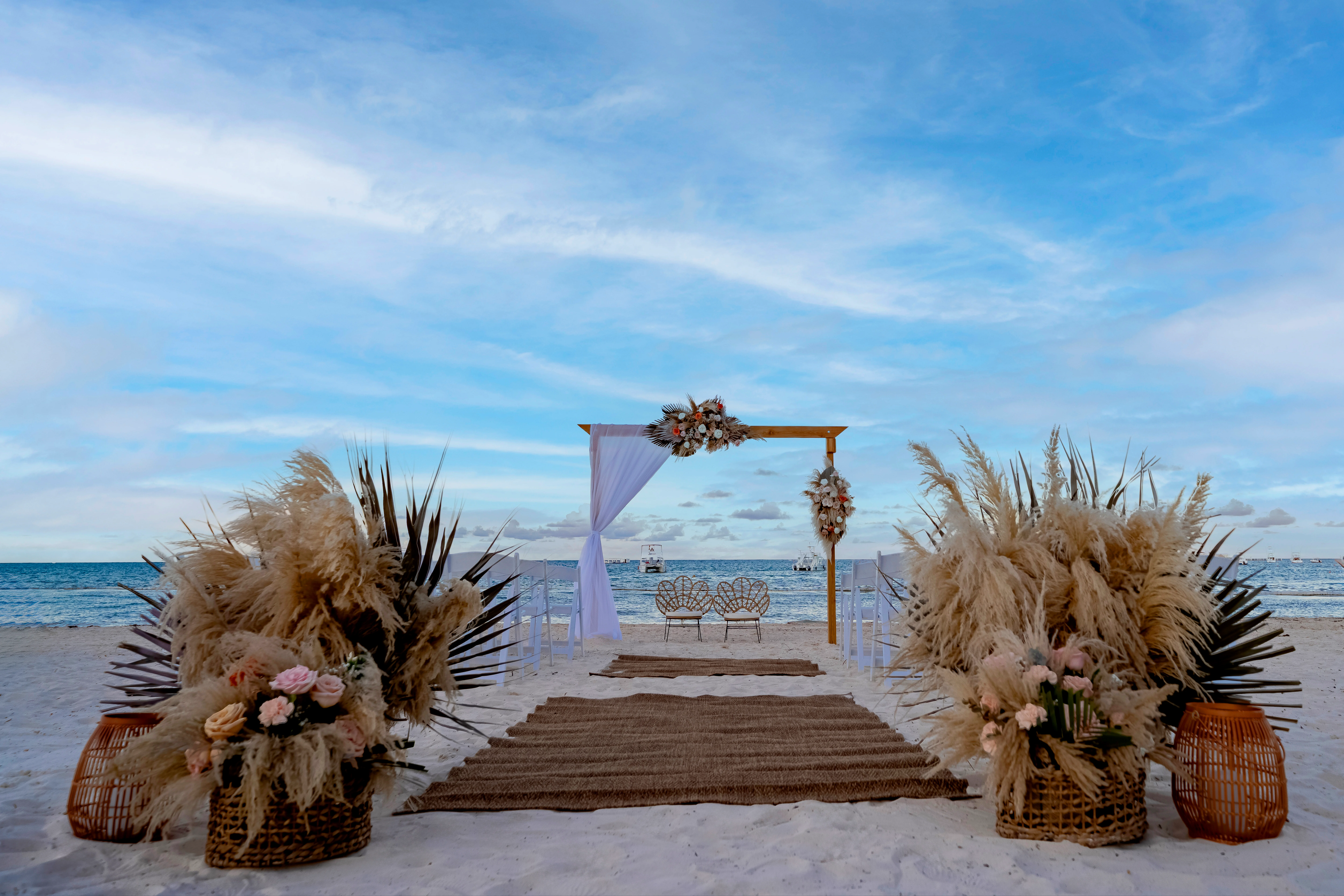 Boho-inspired beach wedding setup with floral decor at Sunscape Coco Punta Cana beachfront.