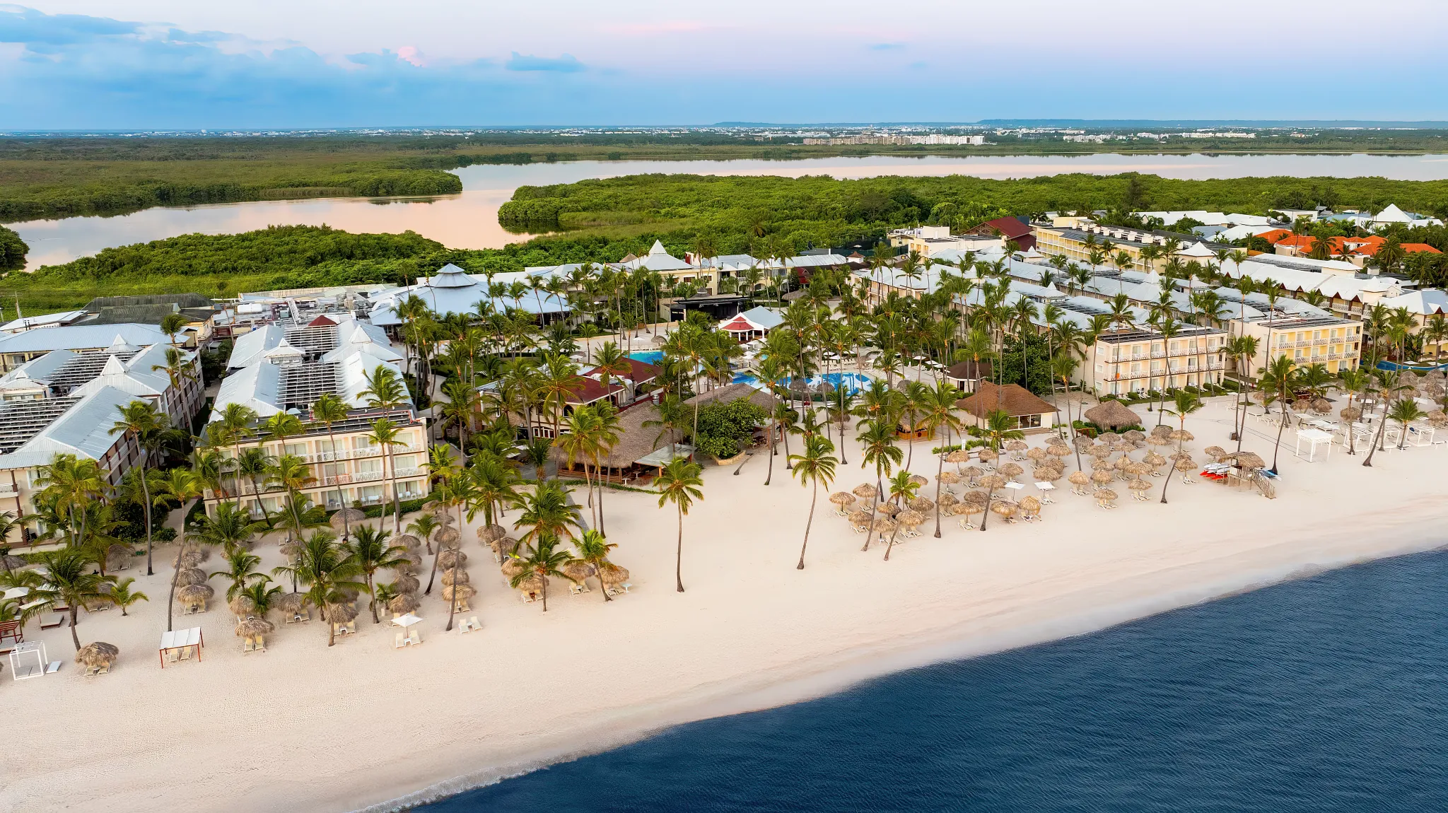 Aerial beachfront view of Sunscape Coco Punta Cana Resort and white sand beach.