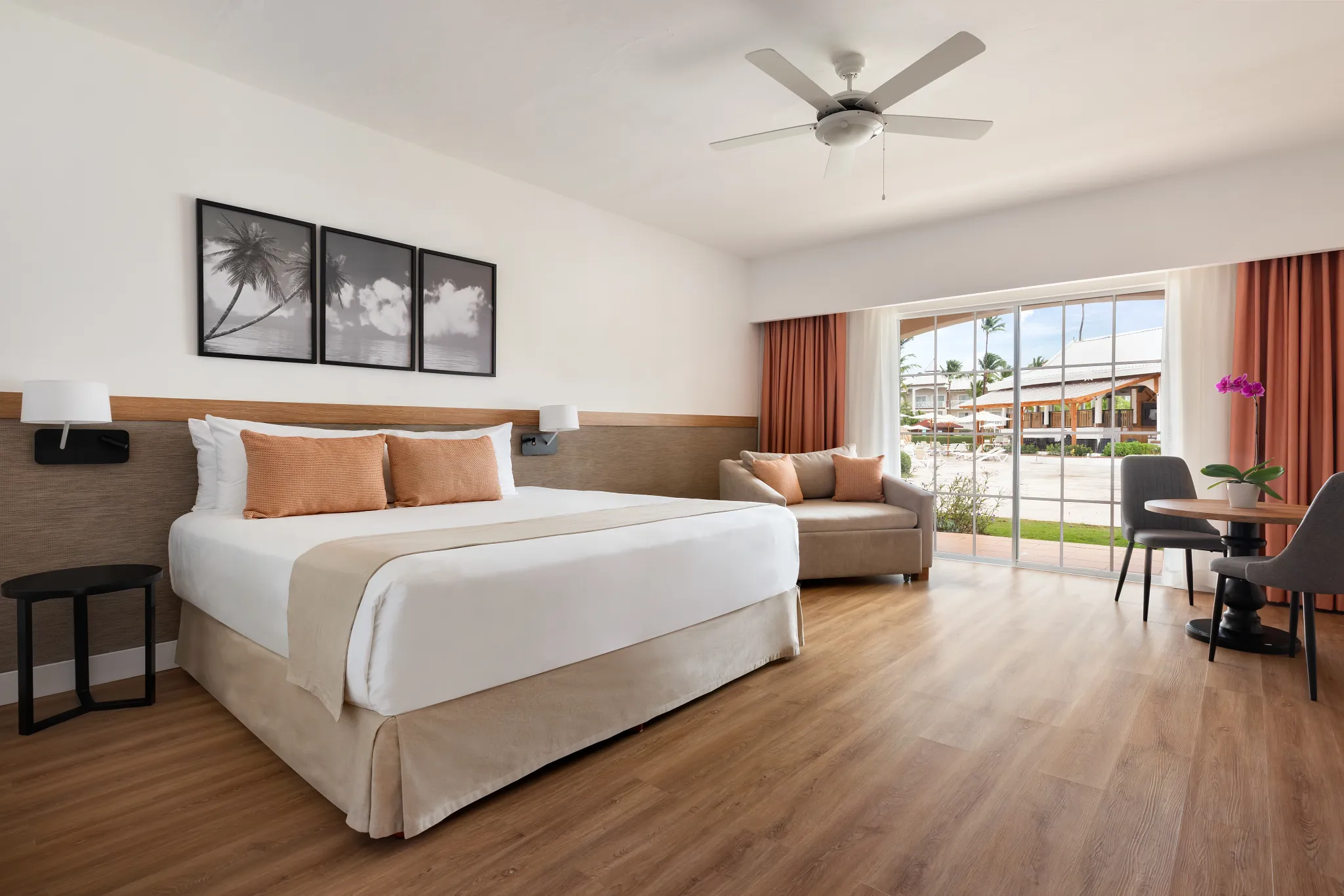 Superior Deluxe Pool View room with king-size bed and terrace at Sunscape Coco Punta Cana overlooking the pool area.