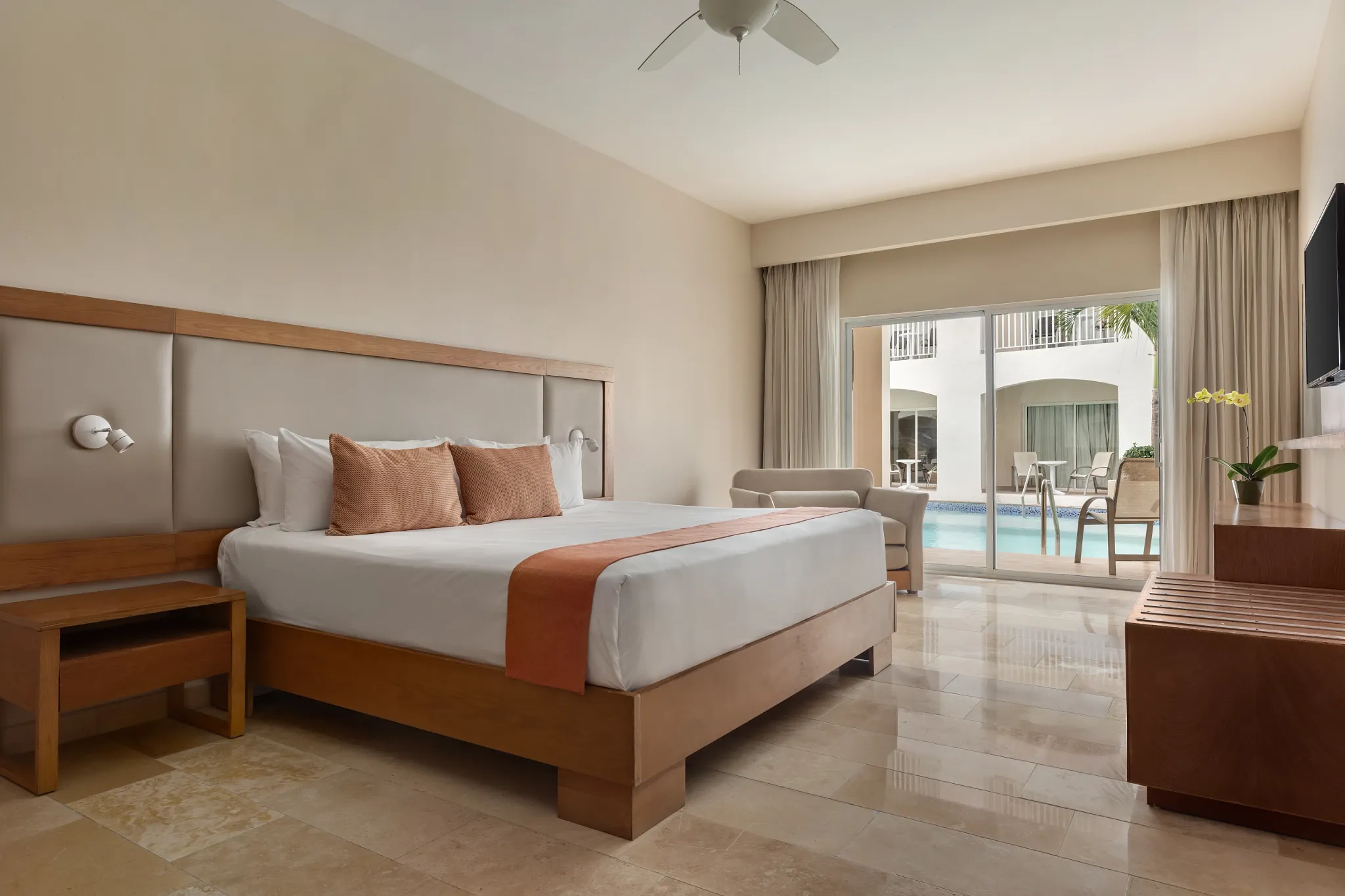 Superior Deluxe Swim Out room with king-size bed and private swim-out terrace at Sunscape Coco Punta Cana.