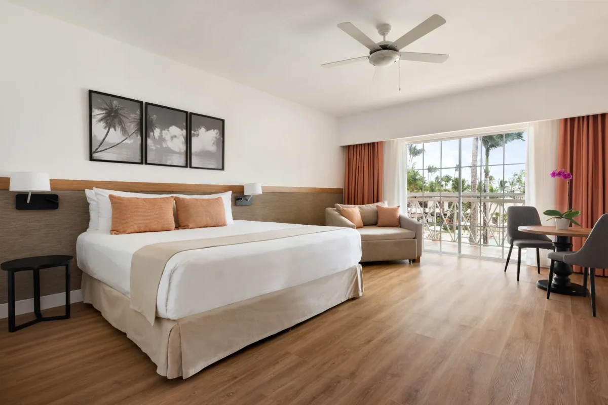 Superior Deluxe Tropical View room with king-size bed and furnished balcony at Sunscape Coco Punta Cana.