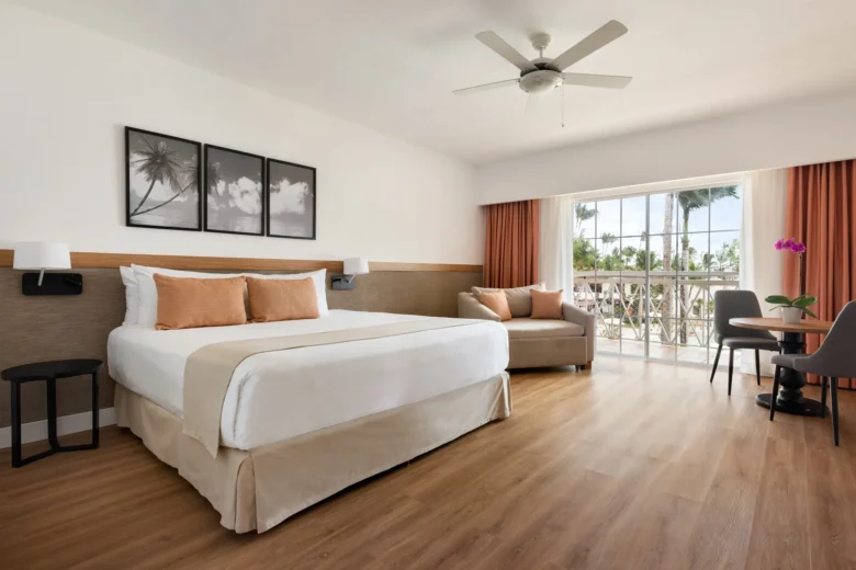 Superior Deluxe Tropical View room with king-size bed and furnished balcony at Sunscape Coco Punta Cana.